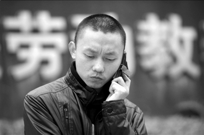 任建宇在勞教所門口接受電話采訪(資料圖片)。本報記者徐曉帆攝