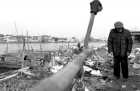 3月14日，新豐鎮(zhèn)的漁民站在岸邊。漁民承包了河道保潔。水面看起來干凈，可是河岸臟了。